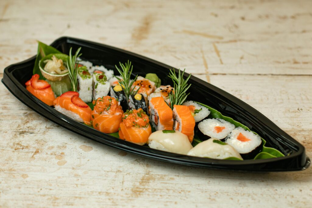 A mouth-watering assortment of sushi including maki, nigiri, and uramaki on a decorative platter.